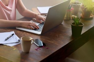 Cropped shot of a woman working on her laptop with a pen and notebook beside herhttp://195.154.178.81/DATA/i_collage/pu/shoots/789845.jpg