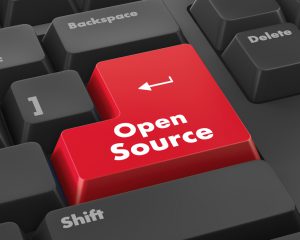 Hand pushing open source keyboard button